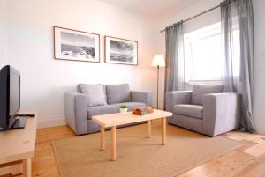 a living room with a couch and a coffee table at 28 House Baleal Island - Ocean view, Patio with barbecue, Perfect location in Baleal