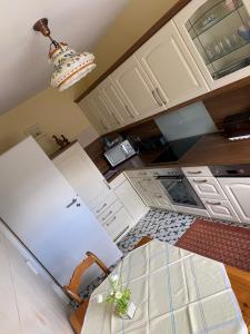 a kitchen with white cabinets and a white refrigerator at Ferien-/Monteurwohnung Linge (Marienheide) in Marienheide