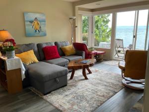 a living room with a couch and a table at Orca View Cottage in Sooke
