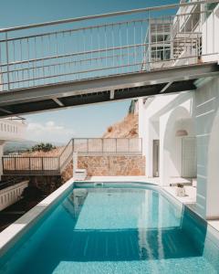 a villa with a swimming pool and a balcony at Porto Kaza in Sitia