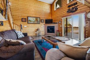 a living room with a fireplace in a log cabin at Garden City Gem in Garden City