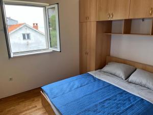 Postel nebo postele na pokoji v ubytování Apartmani Tomić