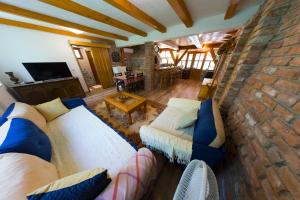 a living room with a couch and a stone wall at Apartment Green Lagoon in Bihać