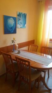 a dining room table with chairs and a table at GABY apartment-center of Plitvička Jezera in Plitvička Jezera