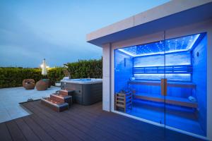 a bathroom with a bath tub on a deck at Villa Pino with Pool, Sauna & Jacuzzi in Petrcane