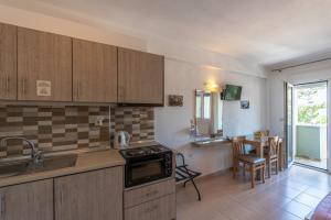 a kitchen with a sink and a stove top oven at Alegria Studios in Chrysi Ammoudia