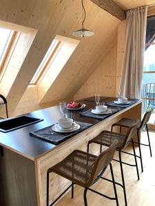 a kitchen with a large island with chairs and tables at Mitterattweng-Florian und Monika Clodi in Traunkirchen