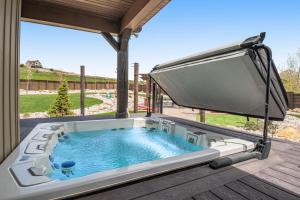 a jacuzzi tub on a deck with a view at Cubbyz Cabin in Garden City
