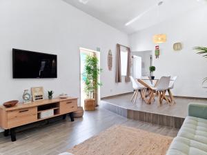 a living room with a tv and a table at CASA VERDE - Beach House, Private Terrace & Pool in Benagil