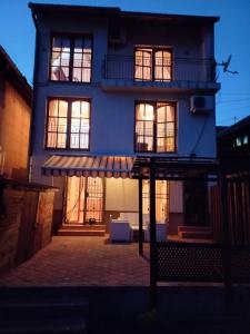 a blue house with an awning in front of it at Villa Kuna in Sarajevo