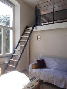 a living room with a loft bed and a couch at Appart situé au sein d'une résidence à Barèges pour 4 à 6 personnes, 1 chambre, 1 mezzanine in Barèges