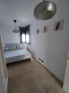 Posteľ alebo postele v izbe v ubytovaní RESIDENCIAL LOS PATOS PLAYA
