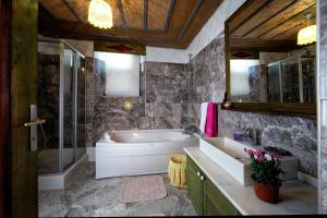 a bathroom with a tub and a sink and a shower at Kadievi in Ürgüp +74 photos