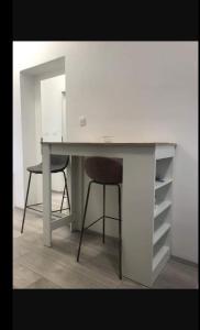 a desk with a chair and a desk with a mirror at Studio Antonio New in Zadar