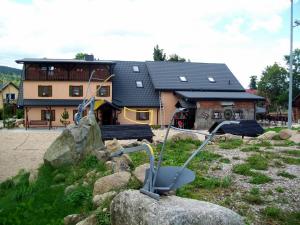 a playground in front of a house with a building at Stara Kuźnia in Sosnówka