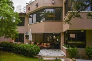 a large building with a patio and an umbrella at Villa Luz in Santa Marta