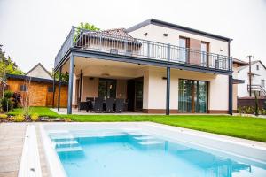 a house with a swimming pool in front of a house at BalaKing in Zamárdi