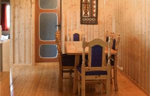 a dining room with a wooden table and chairs at Awesome Home In Hurdal With 2 Bedrooms in Hurdal