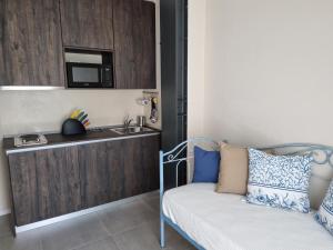 a kitchen with a sink and a couch in a room at Residenza Azzurra in Cattolica