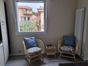 two chairs sitting in a room with a window at Residenza Azzurra in Cattolica