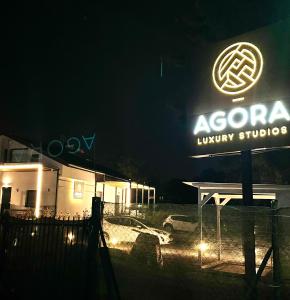 a sign for a hyundai luxury studio at night at Agora LX Studios & Suites in Thessaloniki