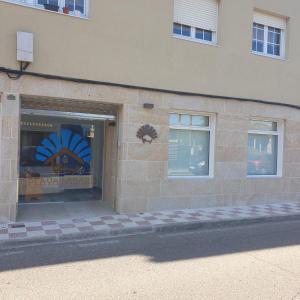 a store front with windows on the side of a building at Albergue playa de sabaris in Sabaris