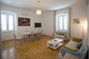 a living room with a couch and a table at Town Place Apartment in Split