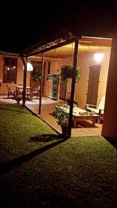 a patio at night with a table and a potted plant at Pampa y Saboya in Villa Elisa