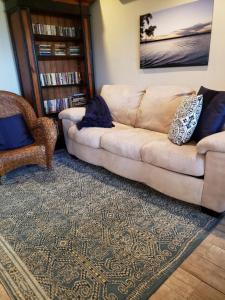 a living room with a couch and a book shelf at Lake front Studio in Little Elm
