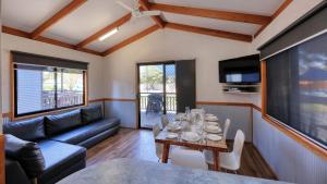 a living room with a table and a couch at BIG4 Swan Hill in Swan Hill