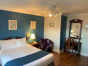 a bedroom with a bed and a desk with a mirror at Braeside Country Inn in Pictou +139 photos