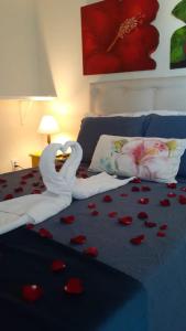 a bed with a swan made out of hearts at La Coloniale in Búzios