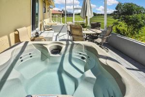 a hot tub on a balcony with a table and chairs at Isles Golf Home in Punta Gorda