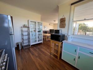 een keuken met een koelkast en een tafel. bij River Panorama Beach House in Guilderton