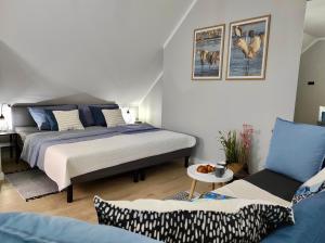 Posteľ alebo postele v izbe v ubytovaní Apartament GRAY CRANE