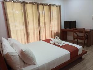 Portofino Panglao Bohol tesisinde bir odada yatak veya yataklar