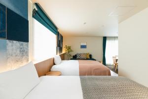Postel nebo postele na pokoji v ubytování Nagi Kurashiki Hotel&Lounge