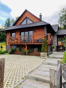 una casa con una gran terraza en la parte delantera en Chata Lipa, en Smrečany