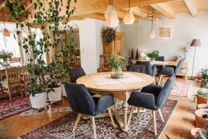 a room with a table and chairs and plants at Bio-Landpension Monika in Leutasch