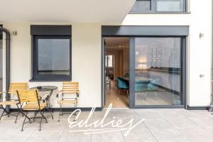 a patio with a table and chairs and a glass door at Eddie’s Design Apartments in Vienna