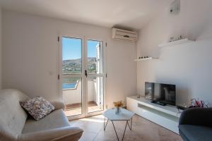a living room with a couch and a tv at Apartment Lazić Pag by Pag tours in Pag