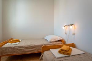 two beds in a small room with two towels at Apartment Lazić Pag by Pag tours in Pag