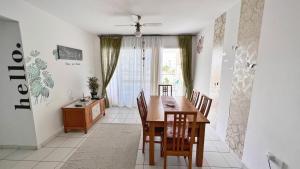 a dining room with a table and chairs and a window at Anthea Gardens - Cosy Condo in Paphos