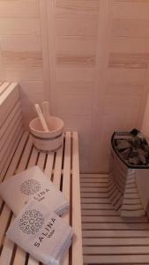 a sauna with two towels on a wooden floor at Salina Premium Residences Volos in Volos