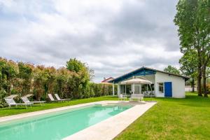 a swimming pool in the yard of a house at Séjour et Forme Route de Biarritz in Arbonne