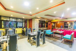 a restaurant with tables and chairs and a bar at Hotel Travel INN in Kathmandu