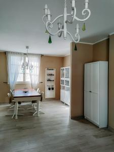 a dining room with a table and a chandelier at The Olive Grove in Tuscany in Toiano +43 photos