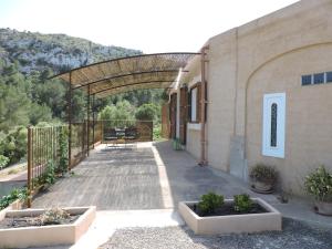 a patio of a building with a bench under an archway at Agroturisme Es Picot in Son Macia