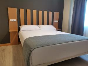 Postel nebo postele na pokoji v ubytování Smart Hotel La Sagra