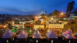 a city lit up at night with white domes at Hotel Travel INN in Kathmandu